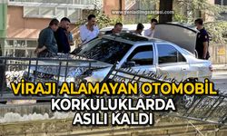 Virajı alamayan otomobil korkuluklarda asılı kaldı