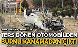 Ters dönen otomobilden burnu bile kanamadan kurtuldu