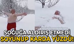 Soğuğa aldırış etmedi, soyunup karda yüzdü