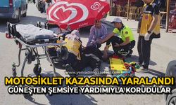 Motosiklet kazasında yaralanan yayayı güneşten şemsiye yardımıyla korudular