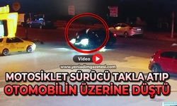 Motosiklet sürücüsü takla atıp otomobilin üzerine düştü