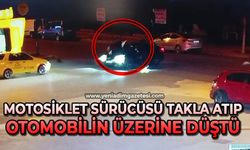 Motosiklet sürücüsü takla attı, otomobilin üzerine düştü