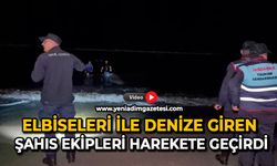 Elbiseleri ile denize giren şahıs ekipleri harekete geçirdi