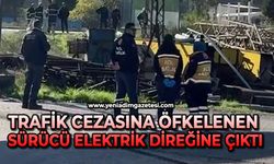 Trafik cezasına öfkelenen sürücü elektrik direğine çıktı