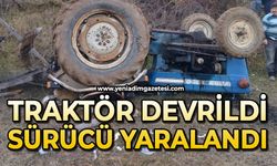 Devrilen traktörün altında kalan sürücü yaralandı