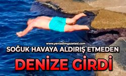 Soğuk havaya aldırış etmeden denize girdi