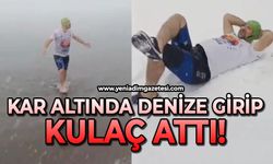 Kar altında denize girip kulaç attı