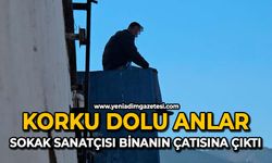 Korku dolu anlar: Sokak sanatçısı binanın çatısına çıktı