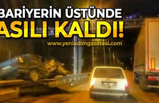 Bariyerin üstünde asılı kaldı