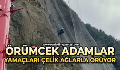 Örümcek adamlar yamaçları çelik ağlarla örüyor