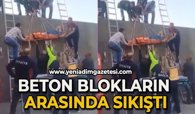 Beton blokların arasında sıkıştı