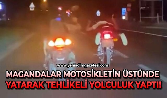 Magandalar motosikletin üstünde yatarak tehlikeli yolculuk yaptı!